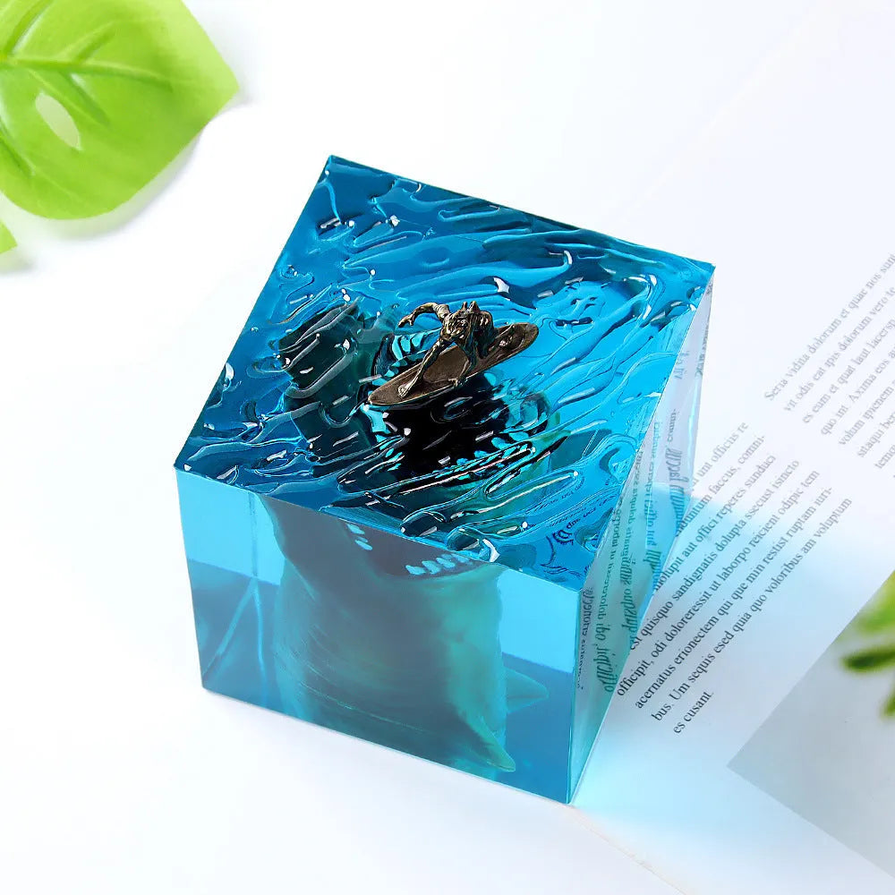 Clear epoxy resin ornament with shark surfer scene inside, next to 5cm and 8cm size options.