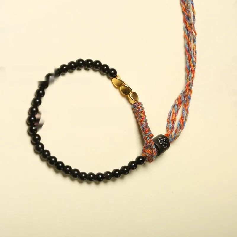 Hand-woven obsidian carrying strap bracelet showing textured surface and 4mm width detail
