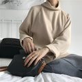 Women's loose fit long sleeve top in solid apricot colour, showing half-high neckline.