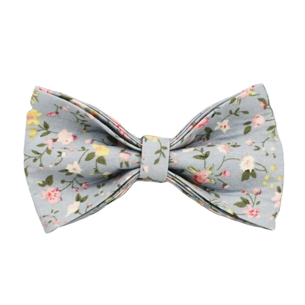 Blue floral pattern dog collar set with matching leash, vest, and accessories on white background