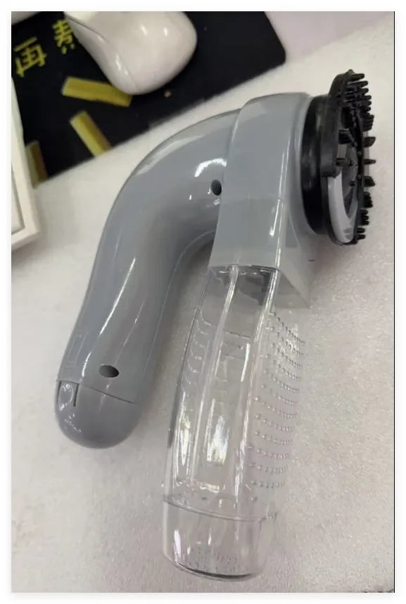 Grey portable electric pet hair vacuum cleaner with soft rubber brush head.