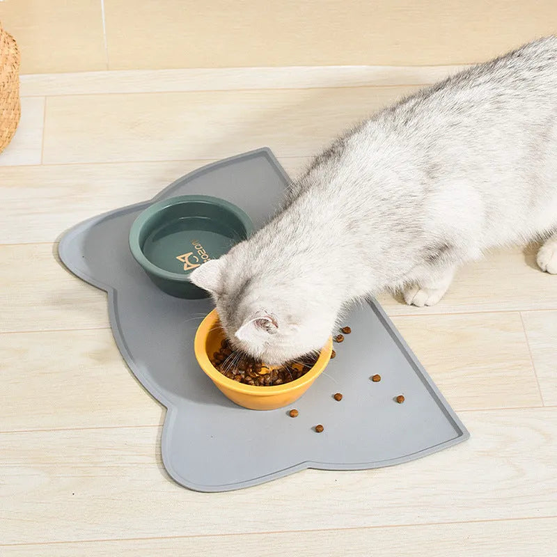 Cat head shaped silicone pet feeding mat in solid colour measuring 44 by 24 centimetres
