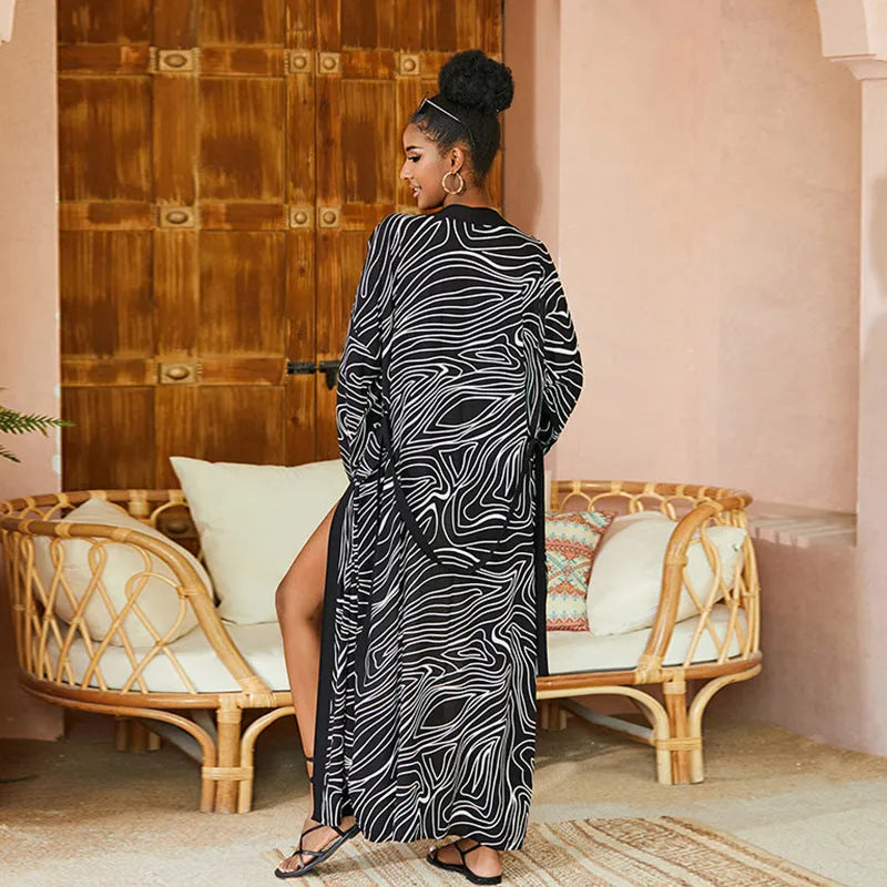 Printed beach cover-up in black white line design on a woman over a bikini, loose fit rayon-cotton tunic