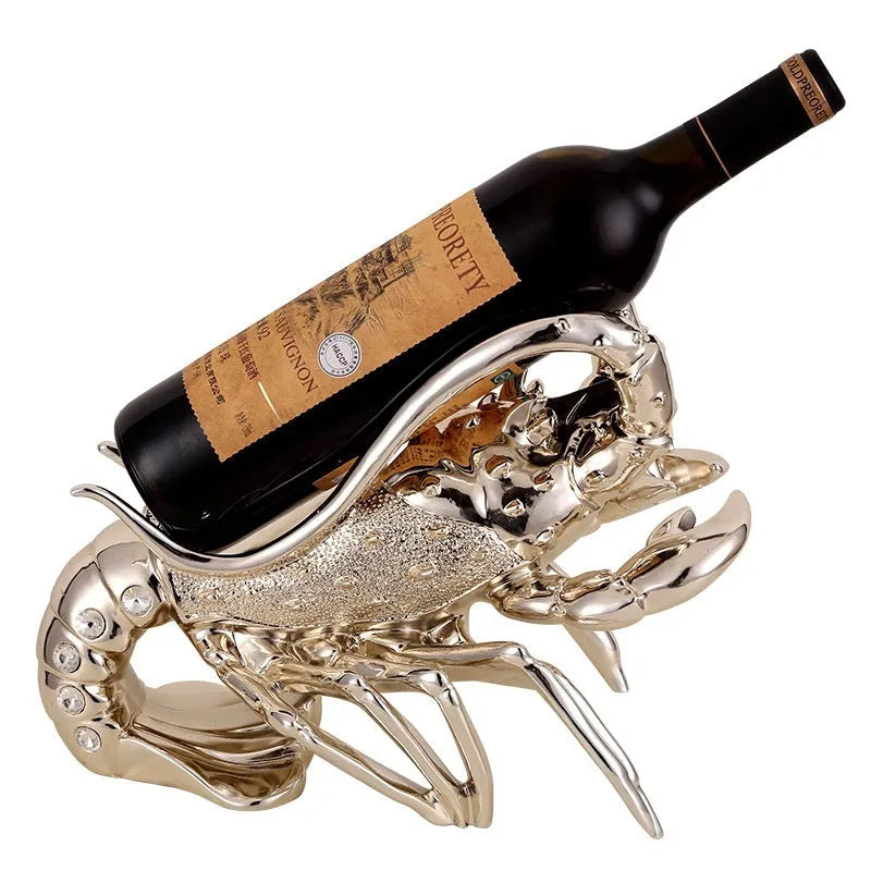 Lobster-shaped natural resin wine rack ornament in rose gold or silver colour on a table.
