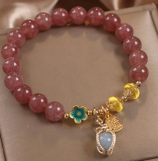 Red strawberry quartz design beaded bracelet for women with alloy metal and rhinestones.