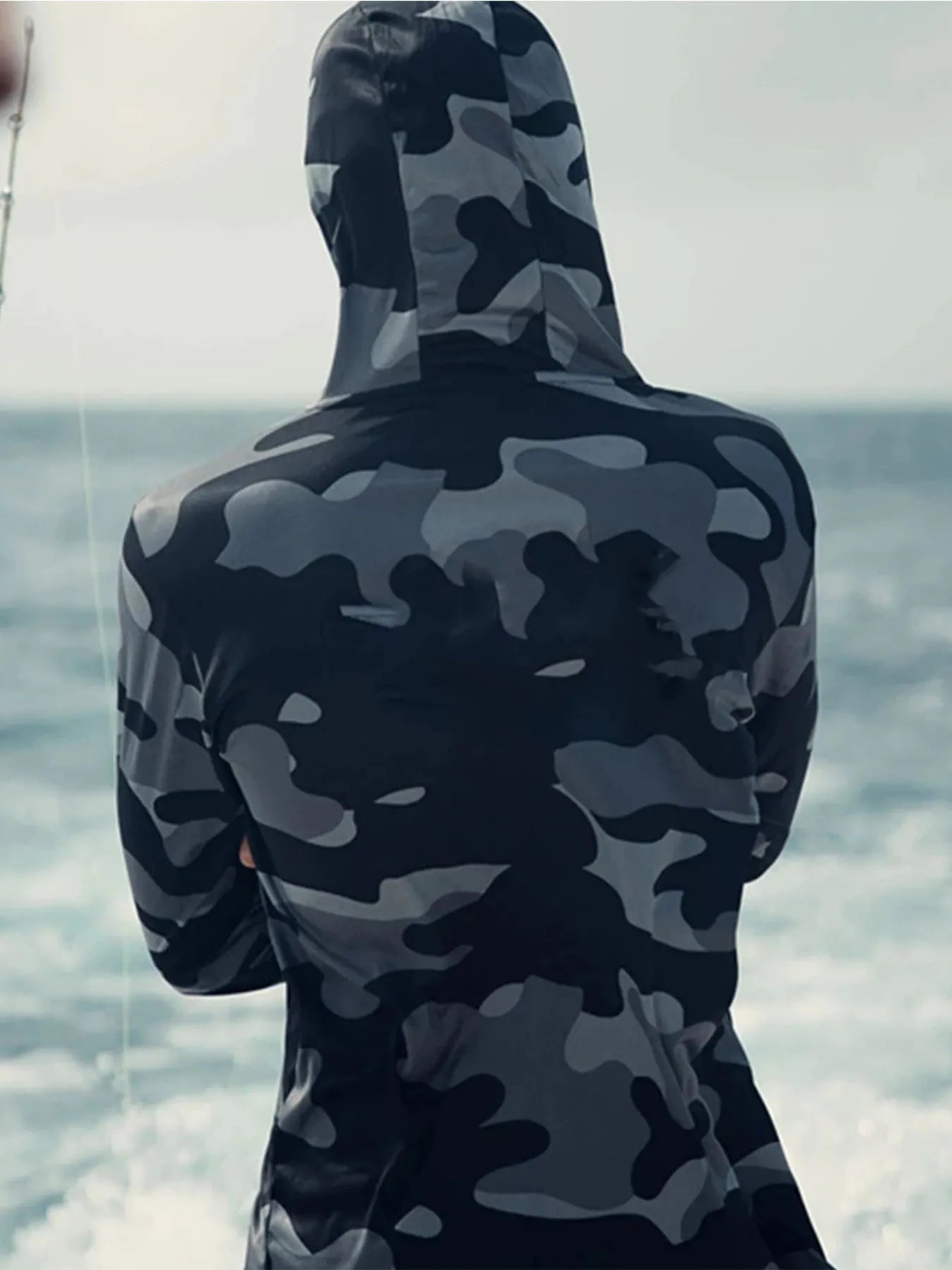Huk long sleeve performance fishing shirt with crew neck and mesh side panels.
