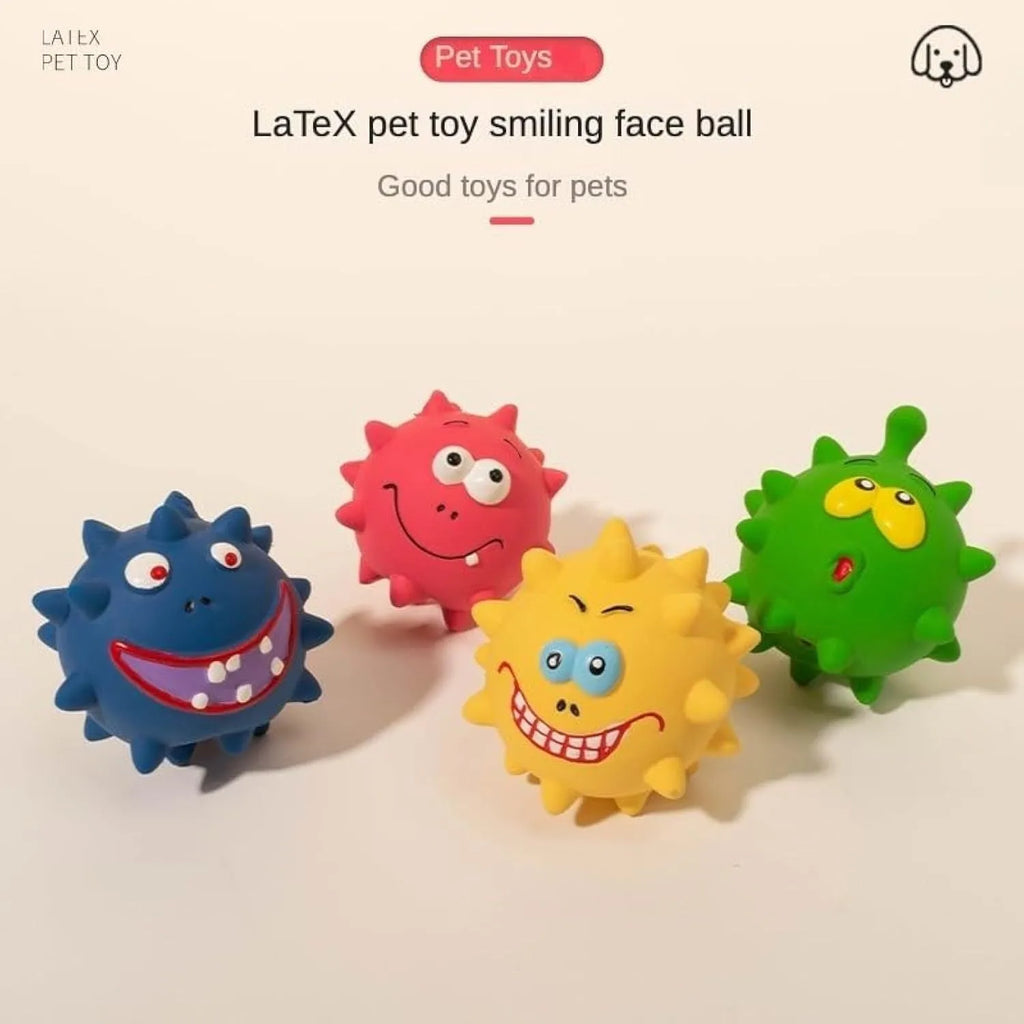 Four colourful squeaky dog balls with cute faces on textured natural latex rubber surfaces