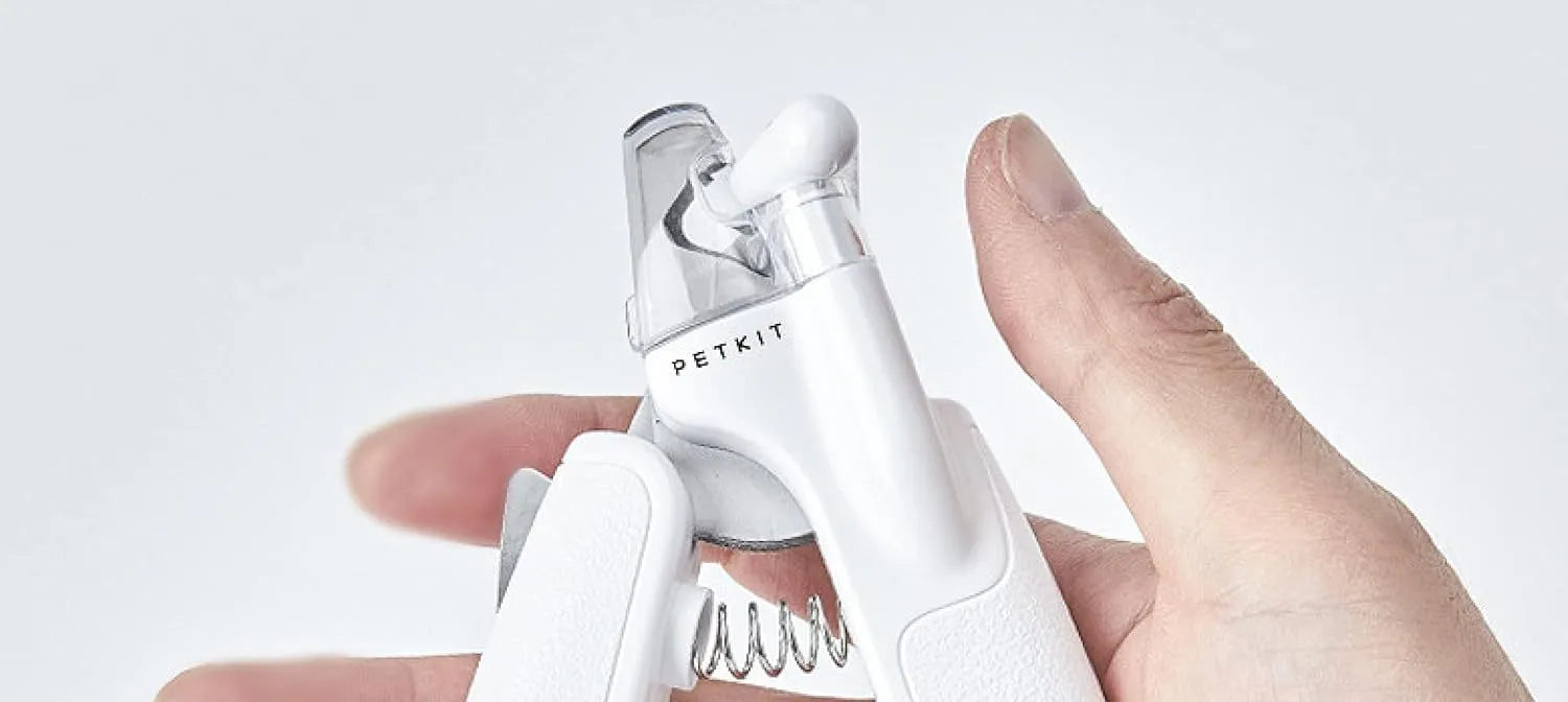 White pet nail clippers with LED light, transparent anti-splash guard open, and separate nail file.