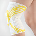 Blue pressurised cotton knee pad for basketball and running sports on adult leg