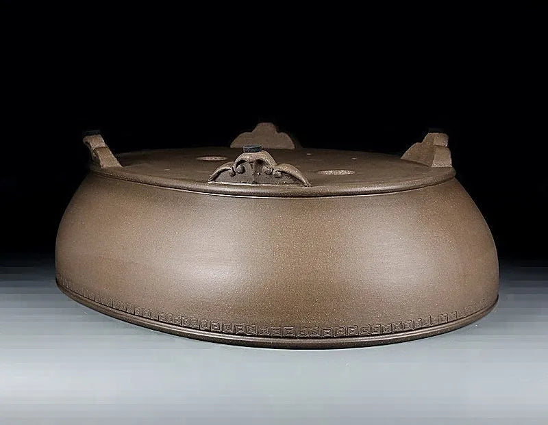 Handmade large oval purple sand flowerpot for plants on a desktop.