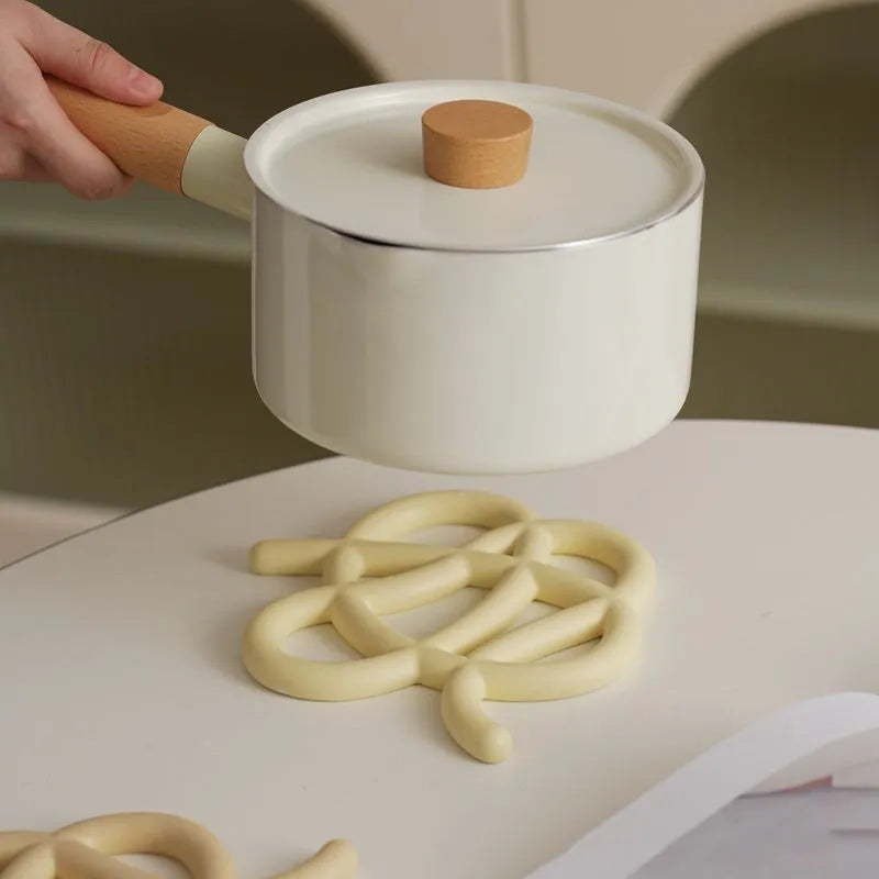 Ceramic heat proof mat with irregular organic shape in solid colour for dining table protection