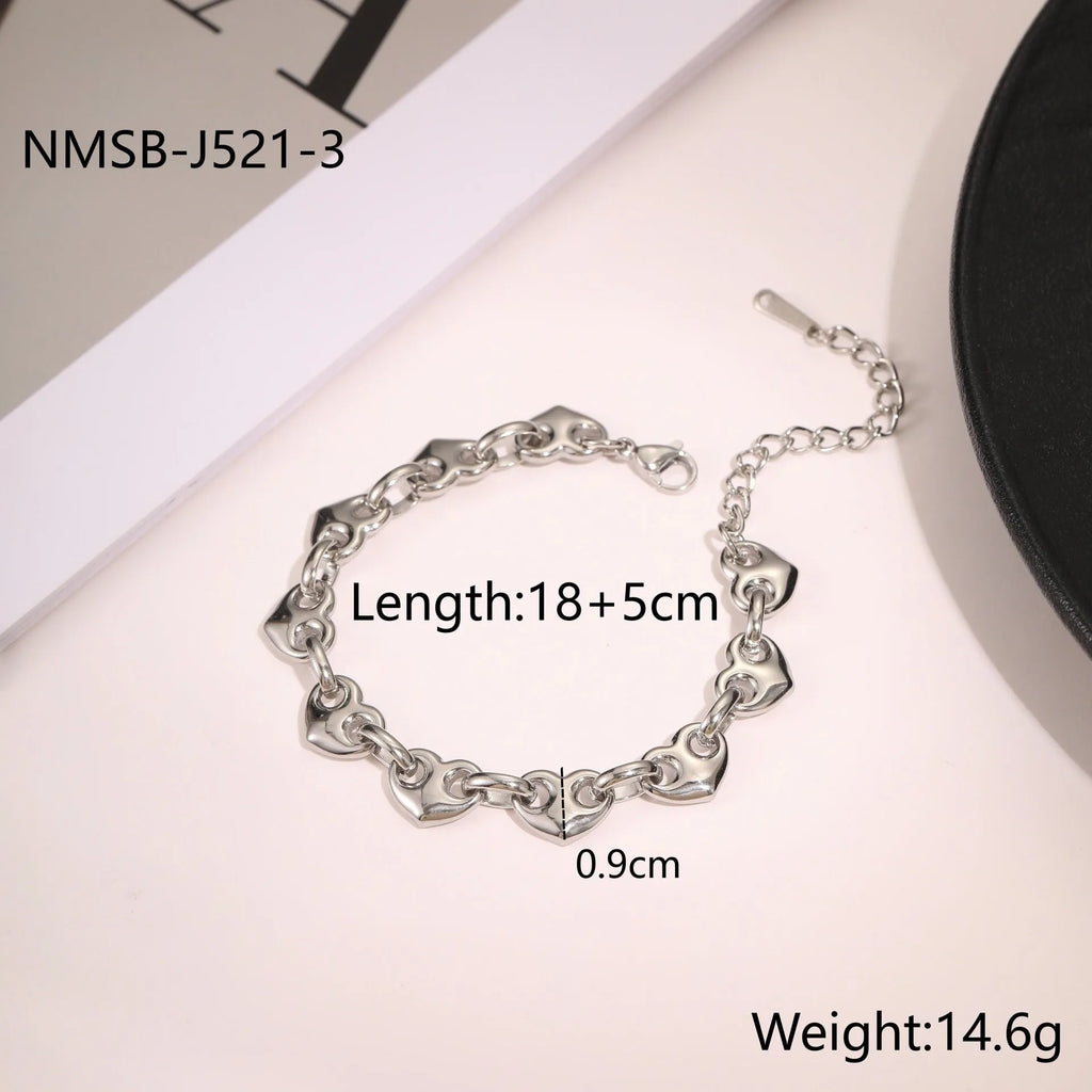 Stainless steel women's bracelet with hollowed-out heart design in gold or steel finish.