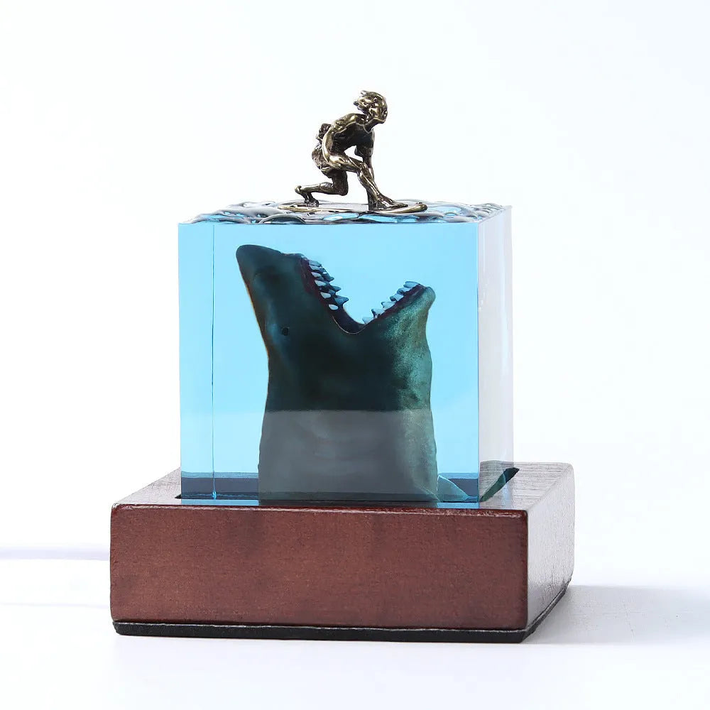 Clear epoxy resin ornament with shark surfer scene inside, next to 5cm and 8cm size options.