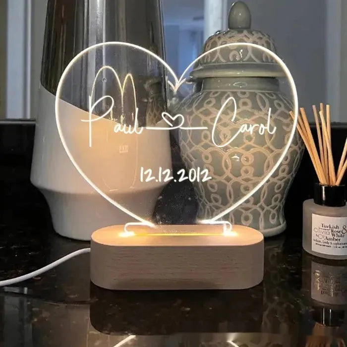 Personalised acrylic night light with engraved names and dates, measuring 20cm by 11.5cm