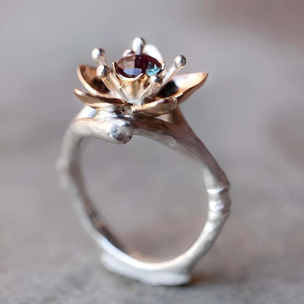 Silver two-tone women's alloy ring with geometric floral pattern, shown on a model finger.