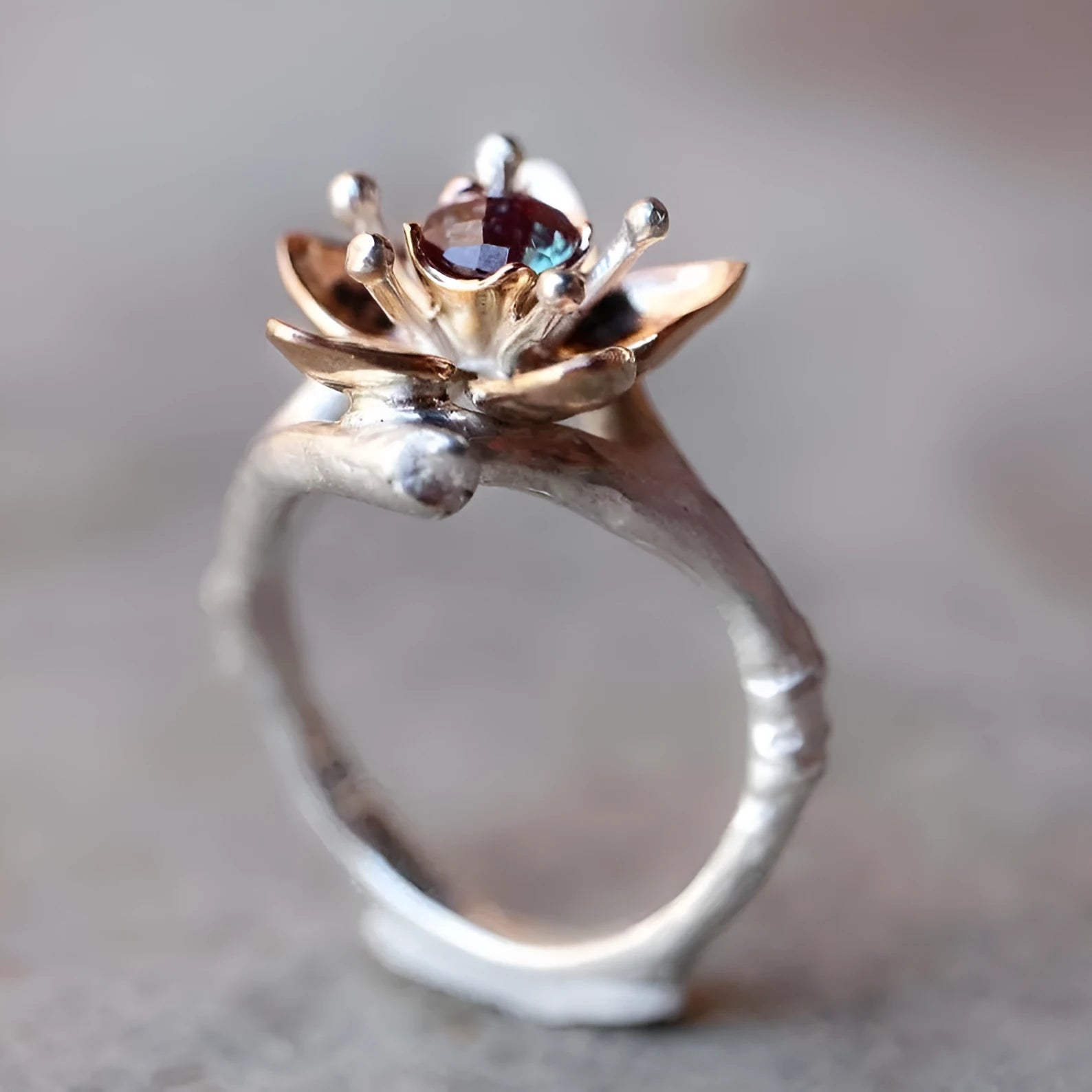 Silver two-tone women's alloy ring with geometric floral pattern, shown on a model finger.
