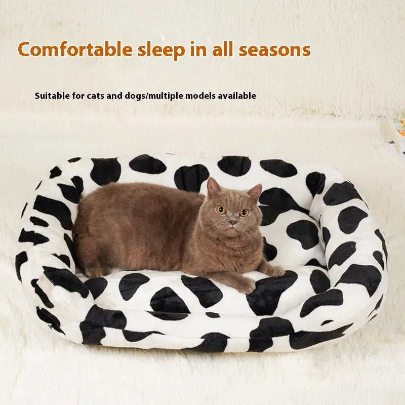 Four Seasons Universal Kennel dog bed in cow colour cloth, size M 40x50cm, with a dog resting on it.