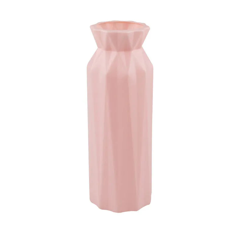 Green melamine plastic vase with 7.2cm base on a wooden table.