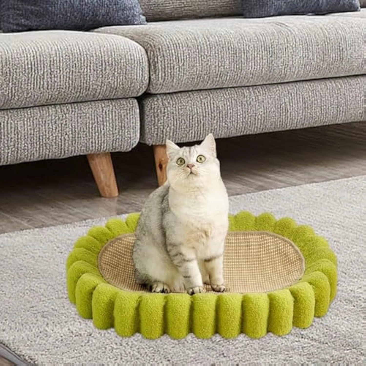 Green oval cat scratch pad and lounger bed made from sisal fabric.
