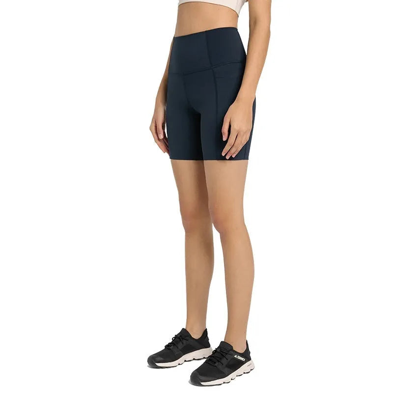 Women's tight-fit cotton blend sports shorts in light purple lotus colour, showing short fifth pants length.
