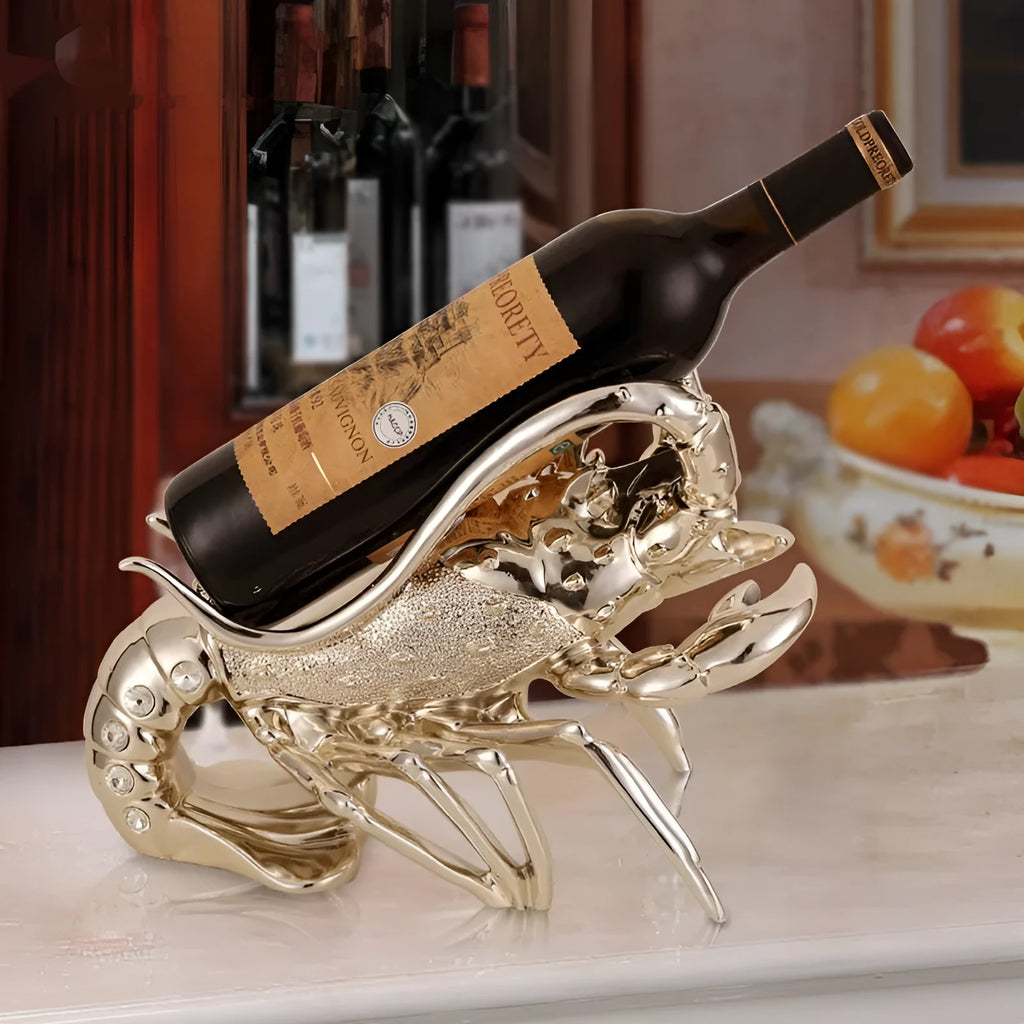 Lobster-shaped natural resin wine rack ornament in rose gold or silver colour on a table.