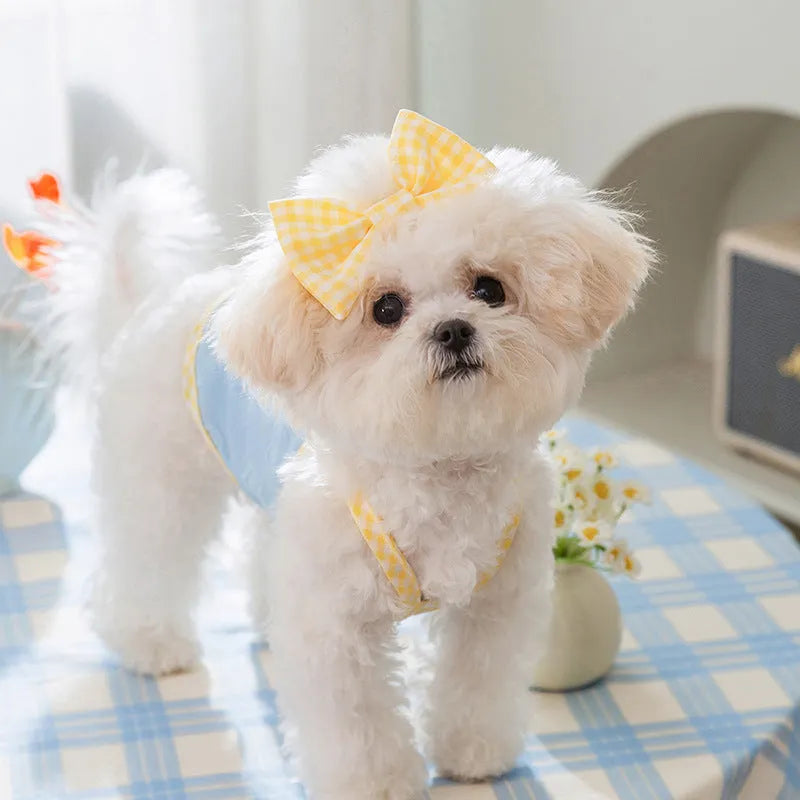 Small dog wearing blue vest with heart texture bow suspenders, elastic construction, casual pet clothing