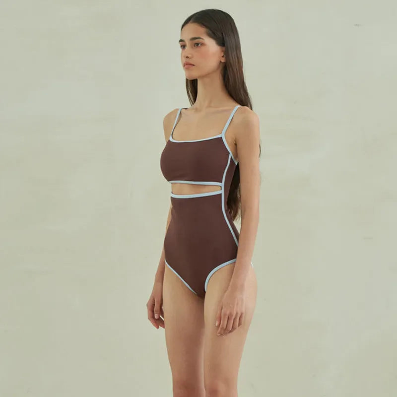 Brown women's triangle one-piece swimsuit with a pattern, shown on a hanger