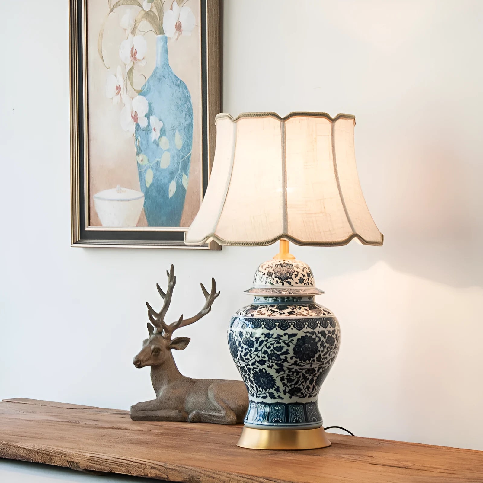 Handmade blue and white porcelain Chinese table lamp with a cloth shade on a wooden surface.