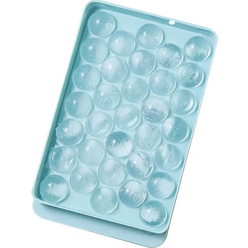 Blue silicone ice cube tray with lid showing 33 round compartments for making ice balls