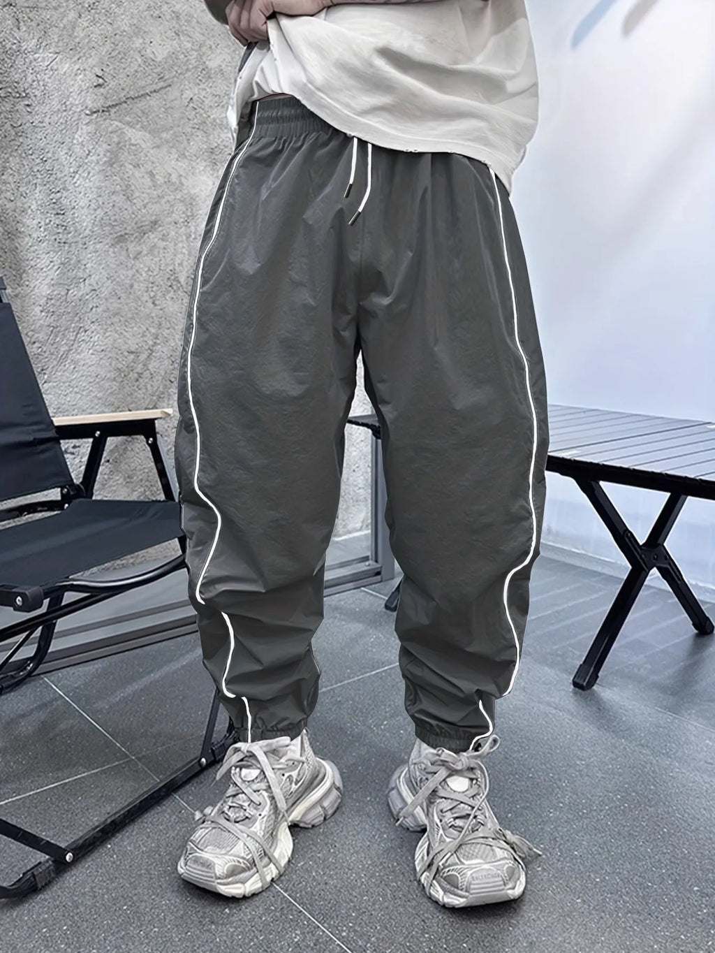 Man wearing loose-fit, cropped-length bamboo fibre sports trousers in Army Green colour.