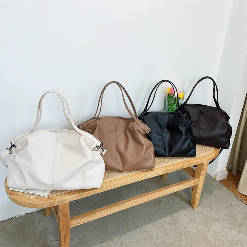 Soft surface large messenger tote bag in black with zipper opening and adjustable shoulder strap