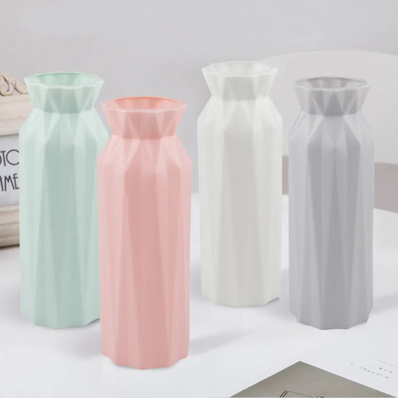 Green melamine plastic vase with 7.2cm base on a wooden table.